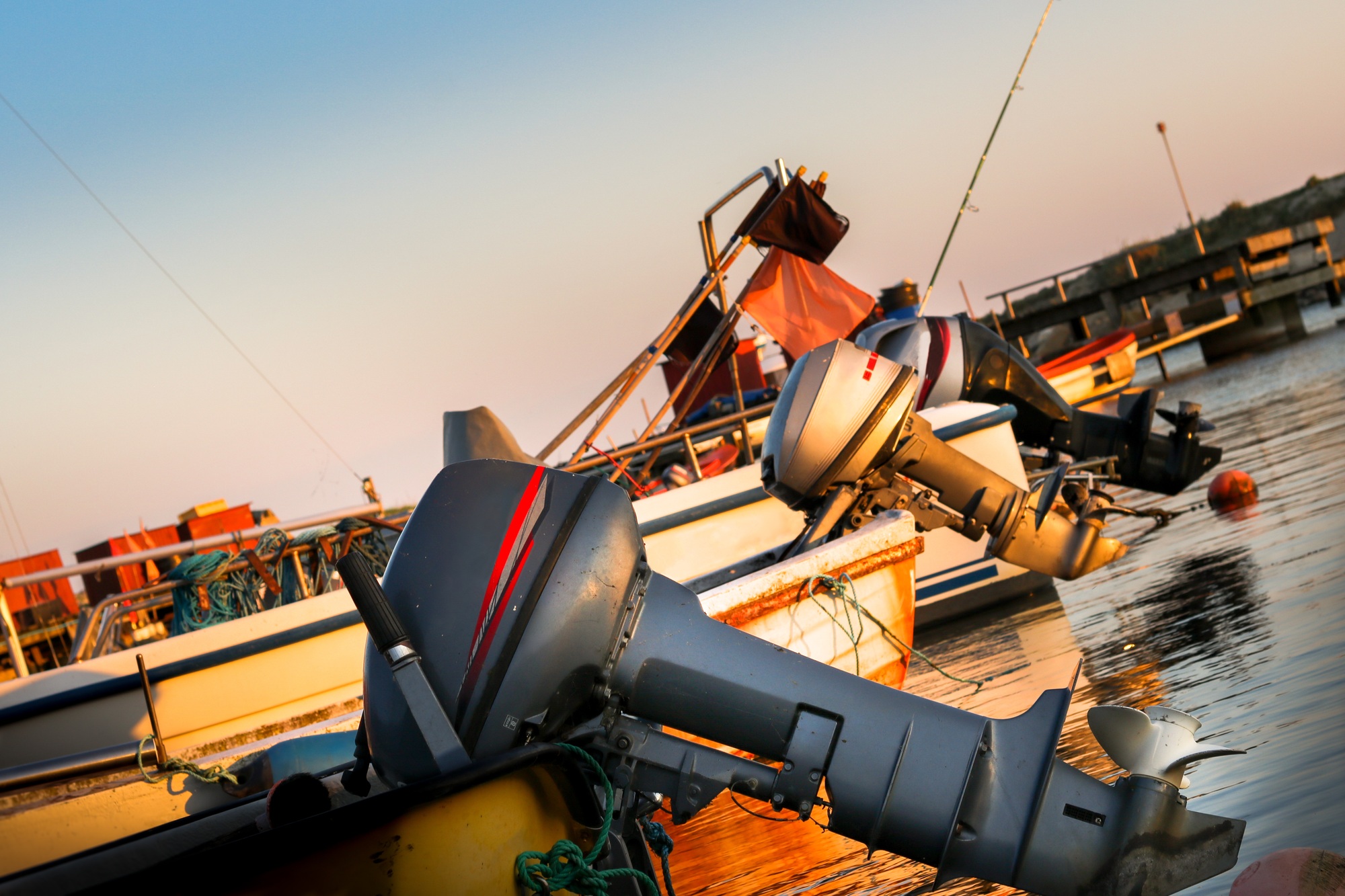 Shot of colorful boats with boat motors on the water surface